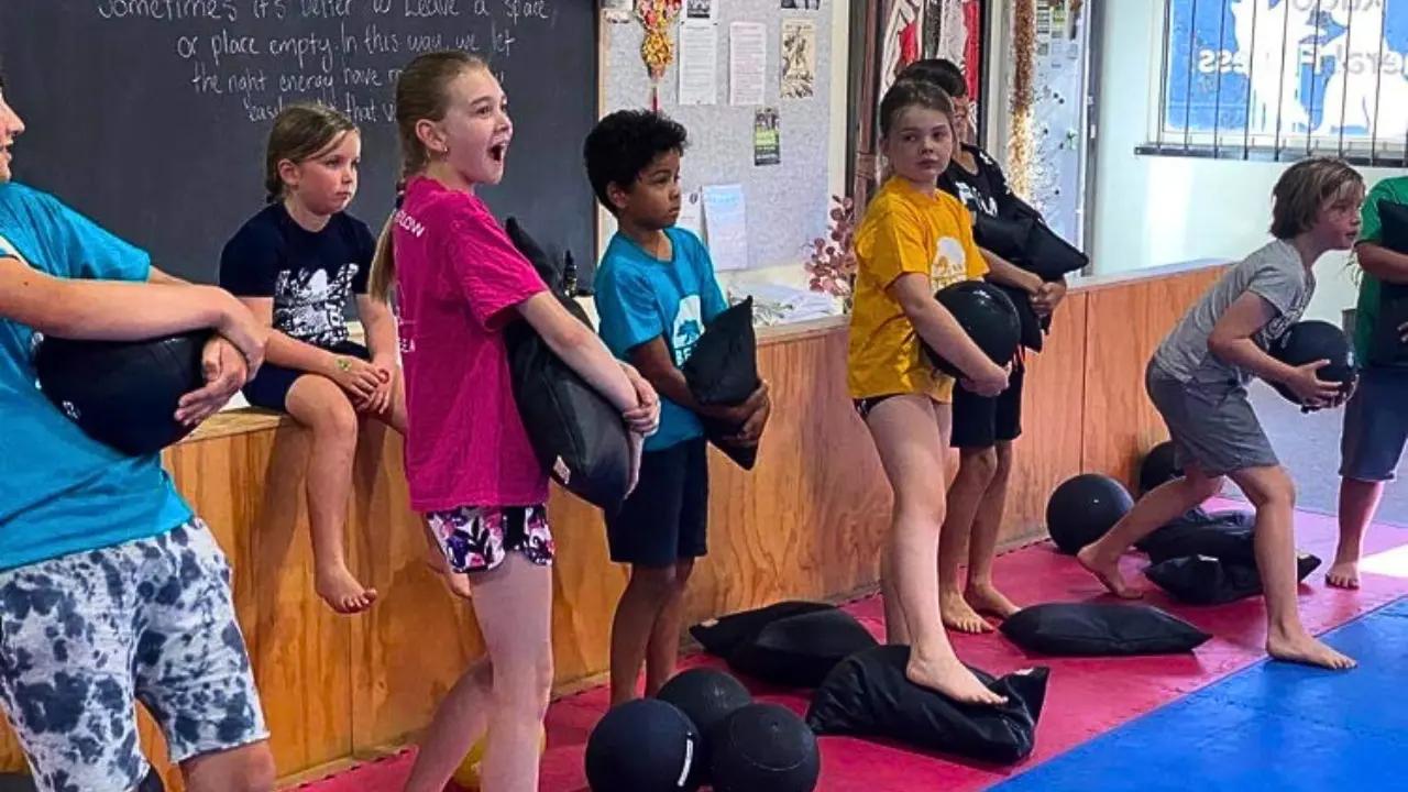 Kids lifting weights during a group fitness class in Melbourne