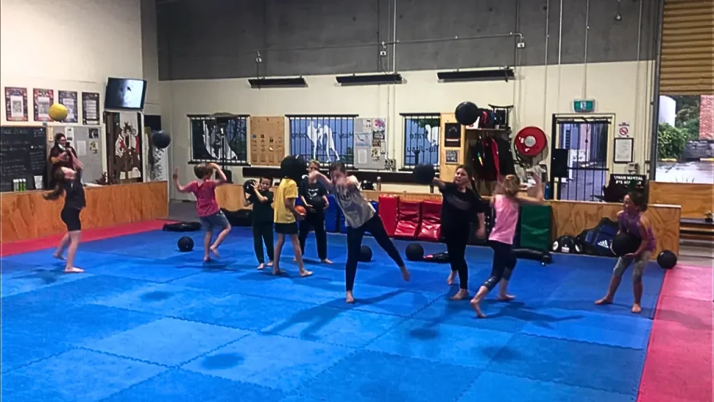 Kids throwing balls during kids functional fitness in Eltham Australia