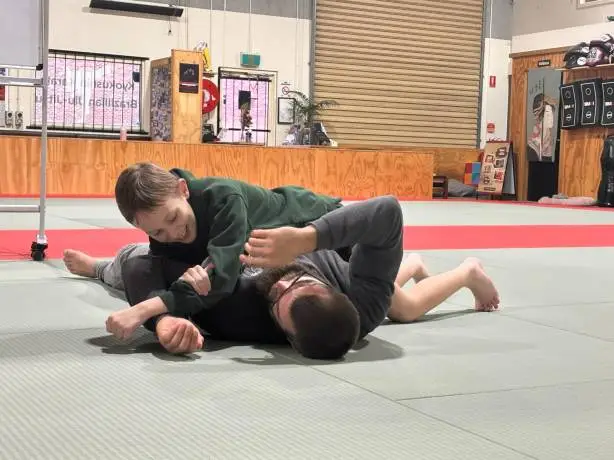 child practicing grappling techniques with a personal trainer at functional fitness eltham