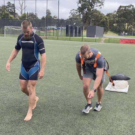 Trainer overseeing a sled drag workout during an outdoor personal training session at Functional Fitness Eltham