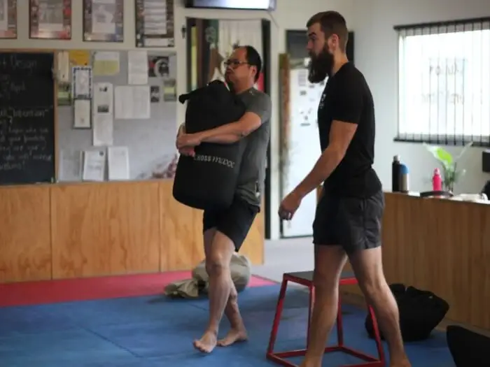 sandbag carry during functional fitness class eltham