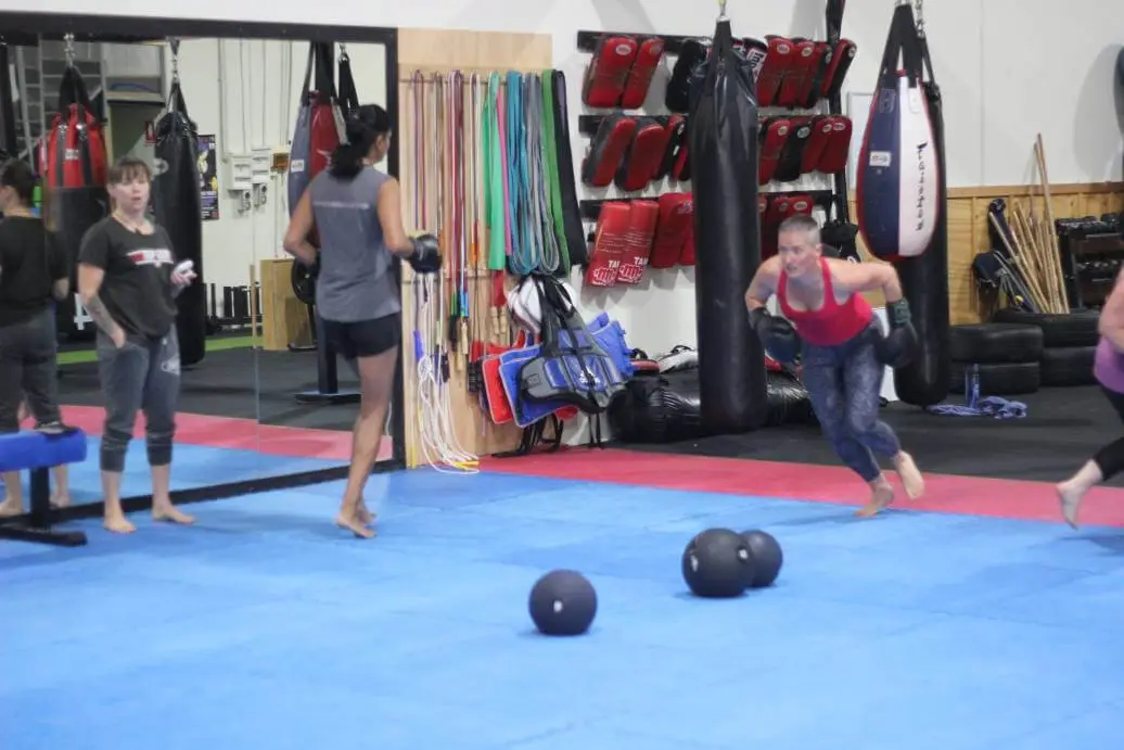 women engaging in various exercises including boxing drills during a women only fitness class at functional fitness eltham