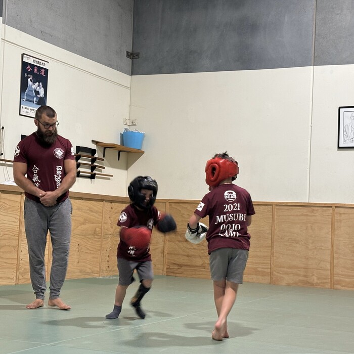 Instructor Willem supervising kids during a martial arts sparring session at Eltham Martial Arts Academy